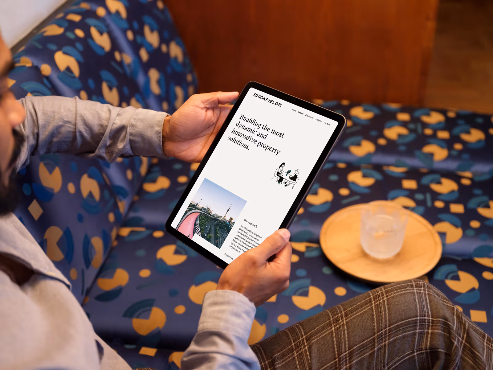 Business man using Brickfields website on an iPad Pro